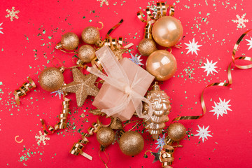Beautiful festive red background with sparkles and Christmas golden toys. Holiday Content. New year...