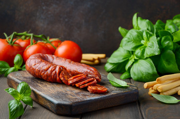 Chorizo sausage. Spanish traditional chorizo sausage with fresh herbs and tomatoes.
