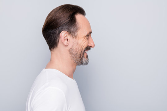 Closeup profile photo of handsome aged man good mood beaming smile looking mirror enjoy mature wrinkles appearance wear white t-shirt isolated grey color background