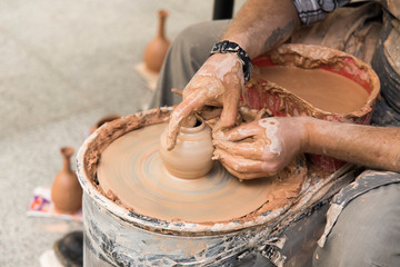 pottery life style hobby action male hands making clay vase dishes object  on a pottery machine
