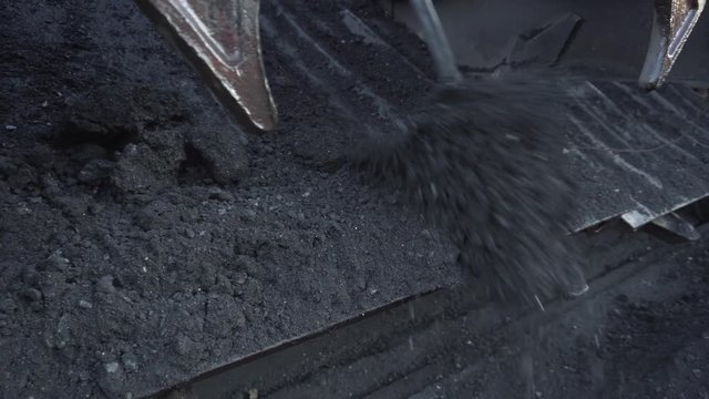 Close-up. Cleaning a railway car from coal. Coal with a shovel is cleaned from the walls of a railway carriage.