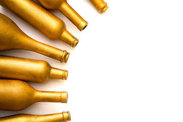 Bottles of different sizes in gold color isolated on a white background.