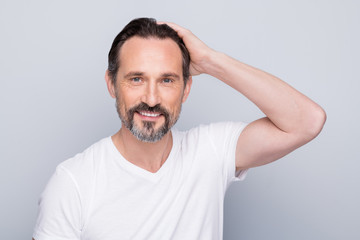 Closeup photo of handsome positive aged man looking mirror hands checking hairstyle after using new hair shampoo conditioner wear white t-shirt isolated grey color background