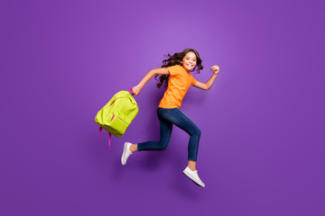 Full length body size view of nice attractive lovely cheerful cheery wavy-haired girl jumping carrying bag running autumn fall 1 first September isolated on lilac purple violet pastel color background