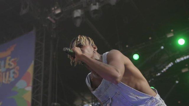 Black rapper in overalls on stage