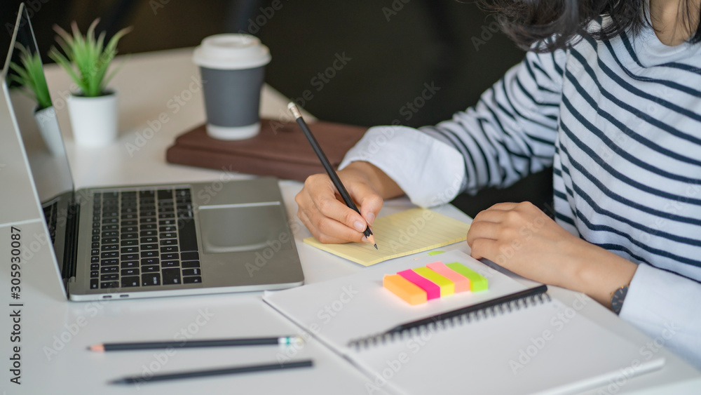 Poster writing report in notebook, closeup of hands writing