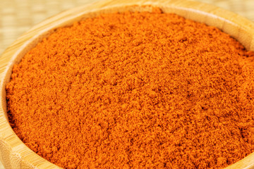 Bowl full of Chili Powder on a bamboo background