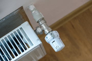 Closeup of heating radiator valve for comfortable temperature regulation on metal radiator on...