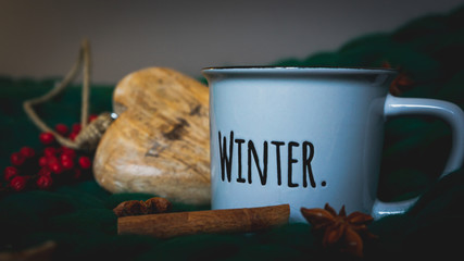 Winter holidays layout. 'Winter' mug on merino wool blanket, with fall fruit and spices