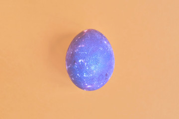 Cosmic galactic Easter egg on yellow pastel background