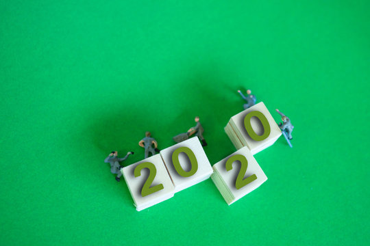 Labor or miniature technicians working. happy New year 2020 on w - Powered by Adobe