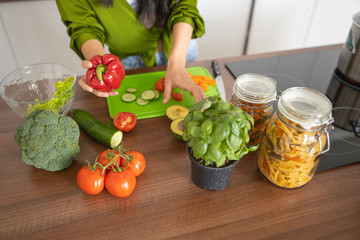 Woman standing at the table with vegetables