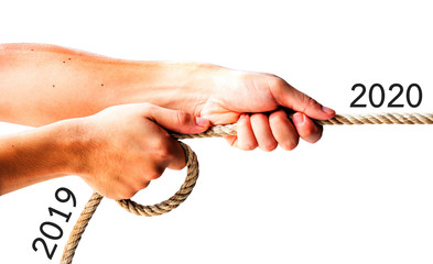 two hand pull the rope with text of 2019 and 2020 new year