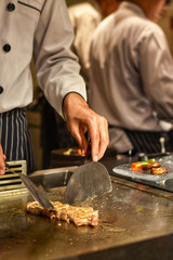 Atmosphere on teppanyaki pan, Chef Japanese is cooking.