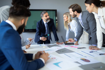 Group of happy business people working in a meeting at office