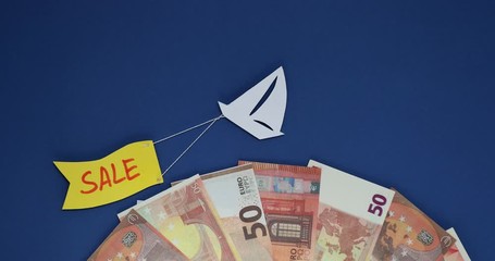 The ship is sailing with a flag sale on the waves of euro banknotes. - Powered by Adobe