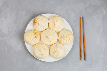 Close up of Chinese steamed dumplings on gray concrete background. Flat lay, top view, overhead, mockup, template. Asian food concept. Traditional food for Chinese New Year celebration