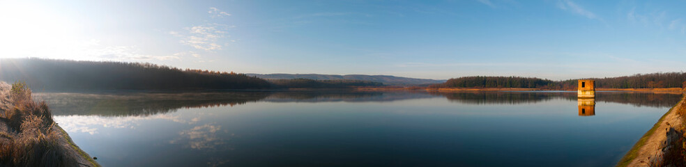 colorful panorama of autumn lake on a bright sunny day