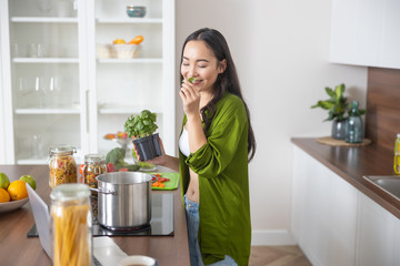 Woman inhaling the aroma of basil leaves