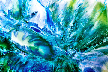 Naklejka premium Abstract liquid paint background. A view from space on an exoplanet sea or ocean. Colorful blue green swirl wave storm
