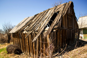One old wooden dilapidated building. Clear day