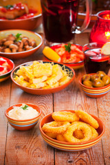 Assortment of Spanish tapas and sangria on a rustic table