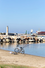 Bike and fishing rod on the beach