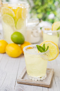 Refreshing lemonade on a rustic outdoor table in bright light