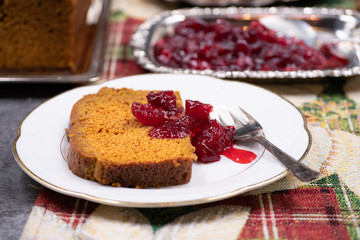 Slice of pumpkin spice bread and craberry sauce
