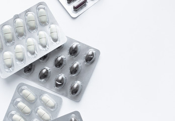 Blisters with pills on white background