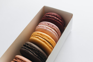 Box with delicious bright macaroons, sweet dessert 