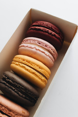 Box with delicious bright macaroons, sweet dessert 