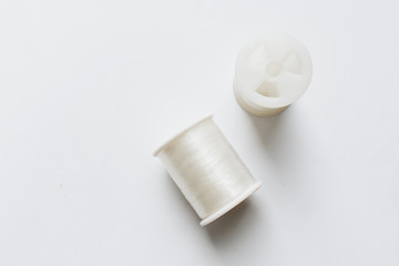 White sewing threads background closeup