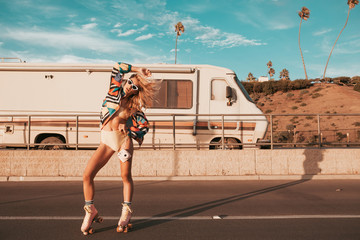 retro style skater girl with a camper van in the background. california lifestyle - obrazy, fototapety, plakaty