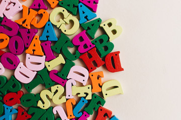 Colorful small scattered wooden letters