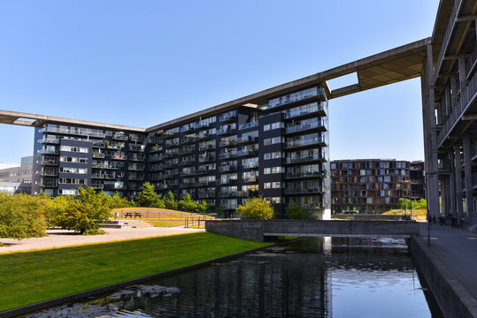Copenhagen / Denmark - 07.24.19: Modern architecture apartments (on Tom Kristensens Vej street, Orestad area) and The Tietgen Residence Hall on background