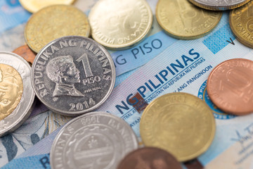 Cash banknote of one thousand Philippines peso and coins paying bills, payment procedure or bribe, salary, close up