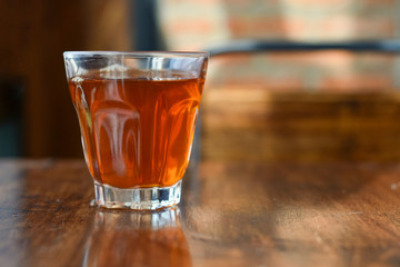 Focus view beverage in a glass on wooden table.