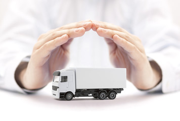 Cargo delivery truck protected by hands - obrazy, fototapety, plakaty