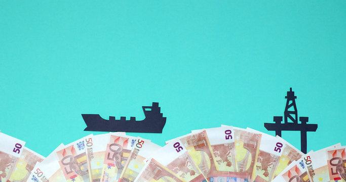 Oil tanker floating against the backdrop of the euro to the oil platform. - Powered by Adobe