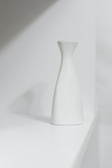 White vase on a wall background 