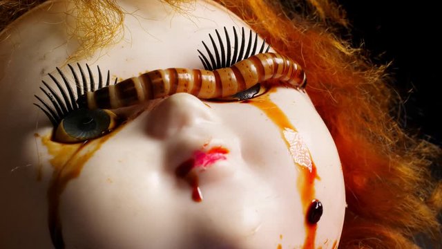 Close up of ugly worms on the old toy. Phobia and horror concept.