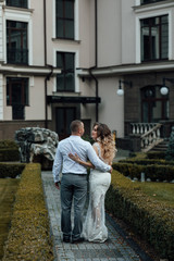 Man with girlfriend embracing her in a park. True love among lovers. Sincere emotions and love on the planet. Beautiful woman with make up and hairstyle. Young couple in love on a autumn day. 