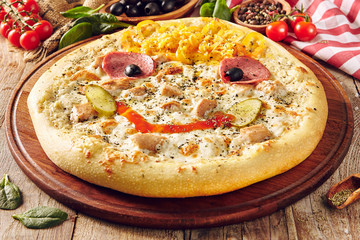 Pizza for children on wooden table closeup