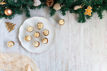 Christmas background, mini carrot cake muffins on a grey rustic table top, flatlay image with empty space