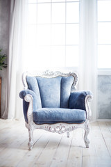 Blue corduroy chair in the classic style in a light interior