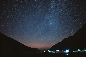 Illuminated camping tent under stars at night. nature reserve Sochi - obrazy, fototapety, plakaty