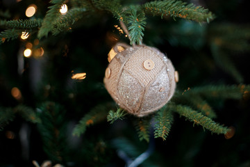 Greeting card. ball on a spruce branch. New Year's toy handmade from beige threads and buttons. It's a cozy Christmas. Copy space