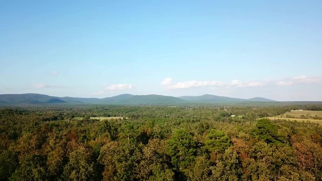 Drone flies over a mountain valley in autumn