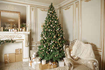 luxurious apartments with decorated christmas tree. Living hall high windows, columns and stucco.